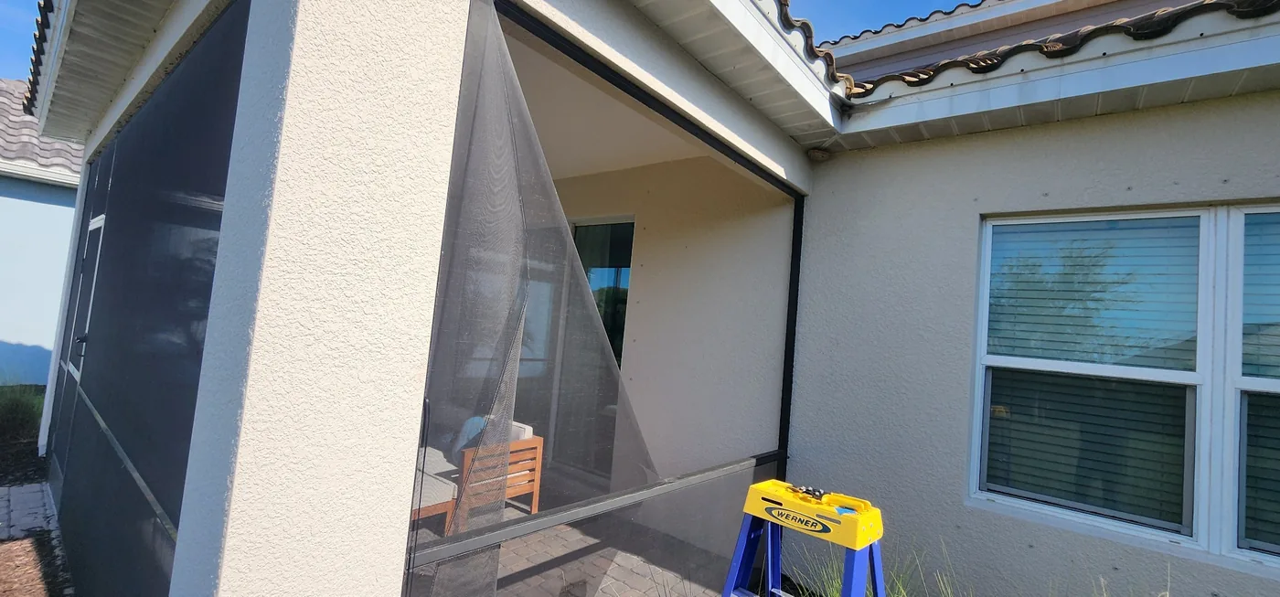 Large patio screen repair work outside home